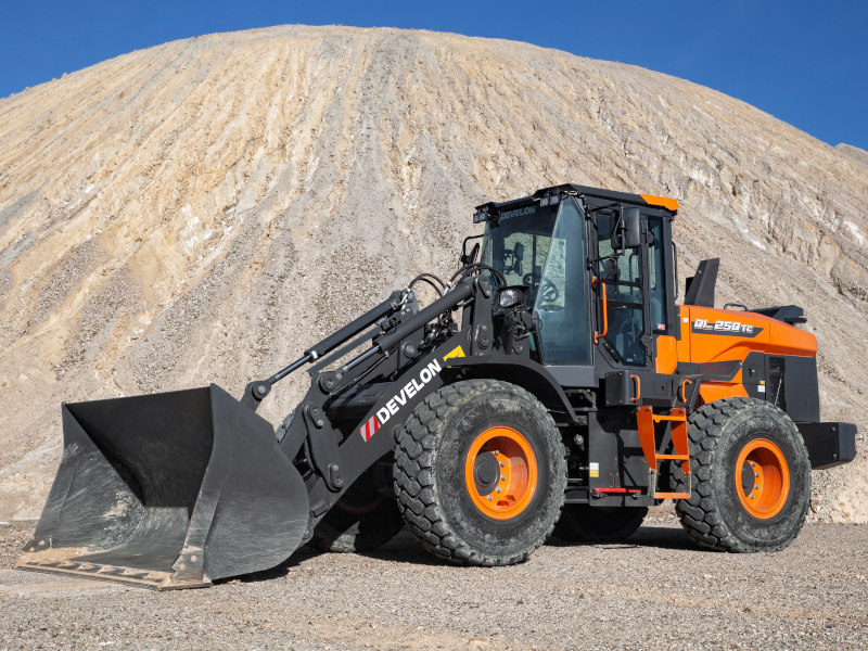 2024 Develon DL250TC parked on gravel under light blue sky